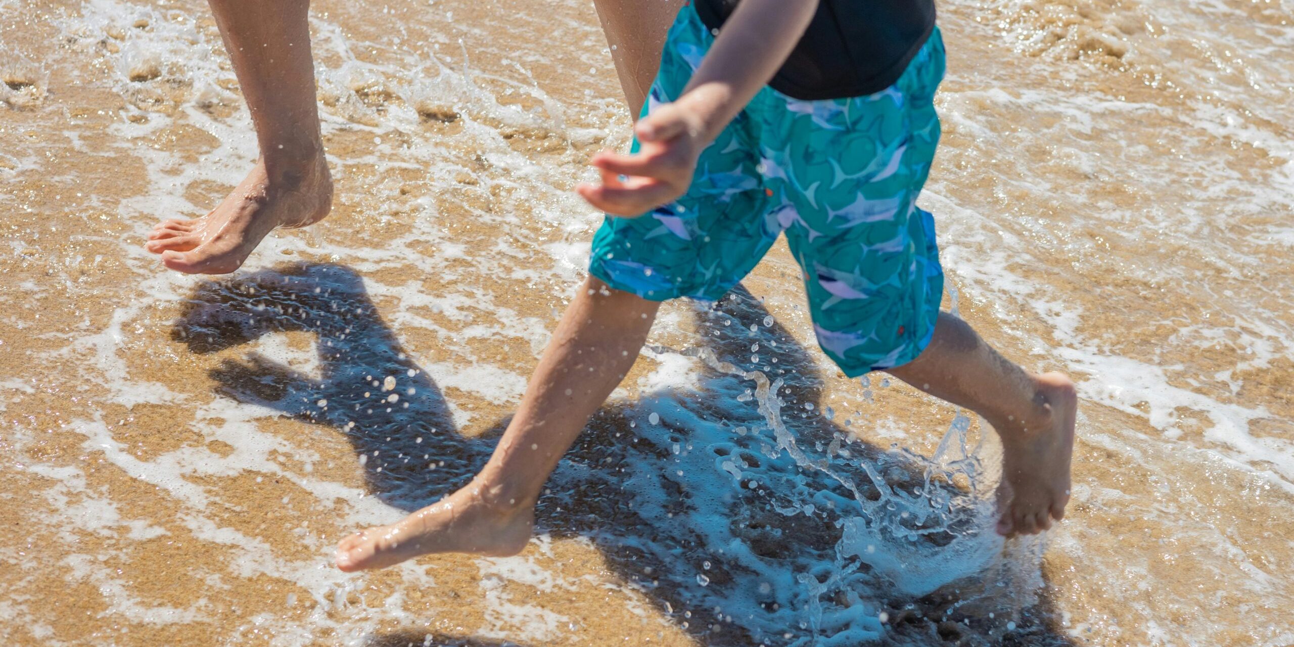 Children's feet splashing in water